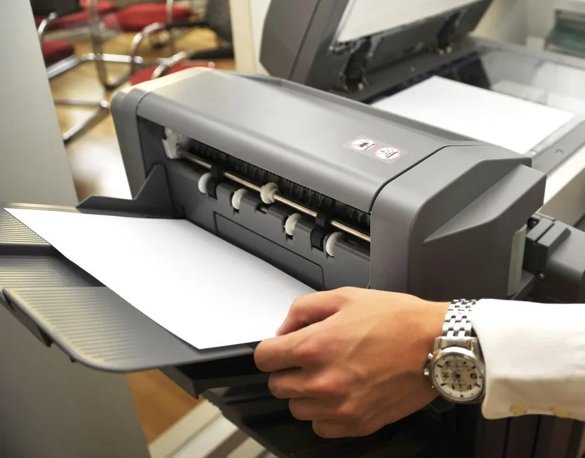 Loading paper into office photocopier